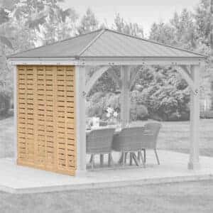 Wooden gazebo with metal roof and privacy screen on a deck, featuring a dining table and wicker chairs in a garden setting.