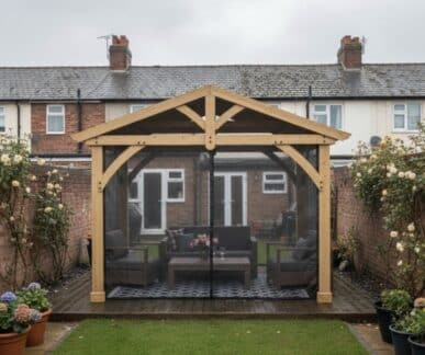 Wooden Yardistry gazebo with mosquito netting and outdoor seating area in a small backyard garden